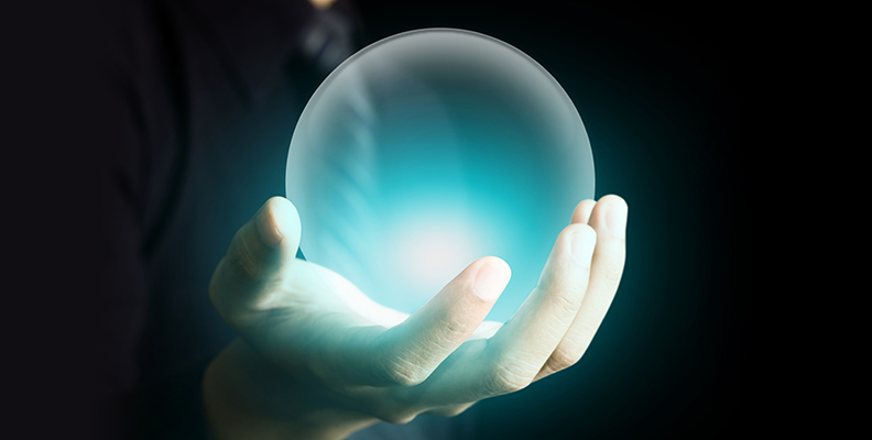 Hand holding a glowing crystal ball